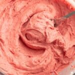 Strawberry frosting with a spoon.