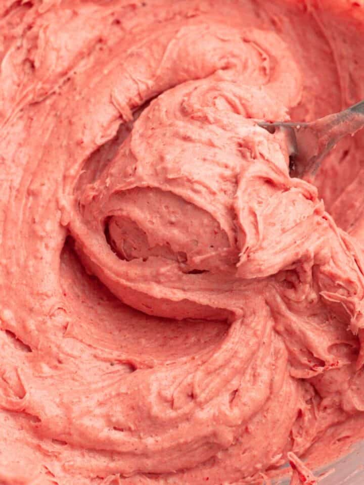 Strawberry frosting with a spoon.