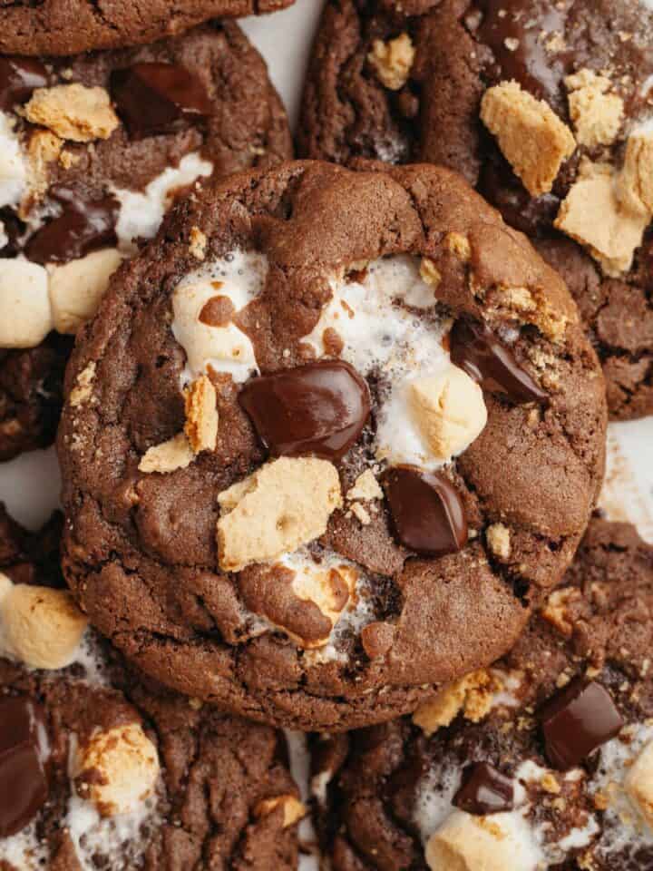 Several chocolate s'mores cookies on parchment paper.