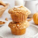 Two pumpkin banana muffins stacked on top of each other.