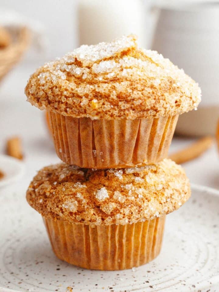 Two pumpkin banana muffins stacked on top of each other.