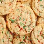 A close up of Christmas sprinkle sugar cookies with red, white, and green sprinkles.