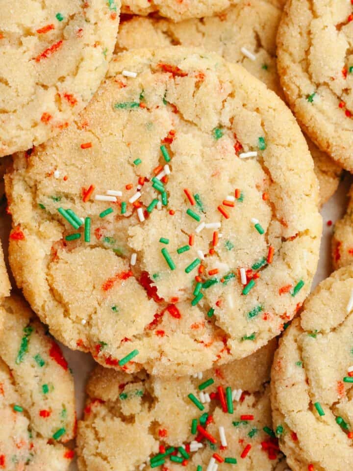 A close up of Christmas sprinkle sugar cookies with red, white, and green sprinkles.