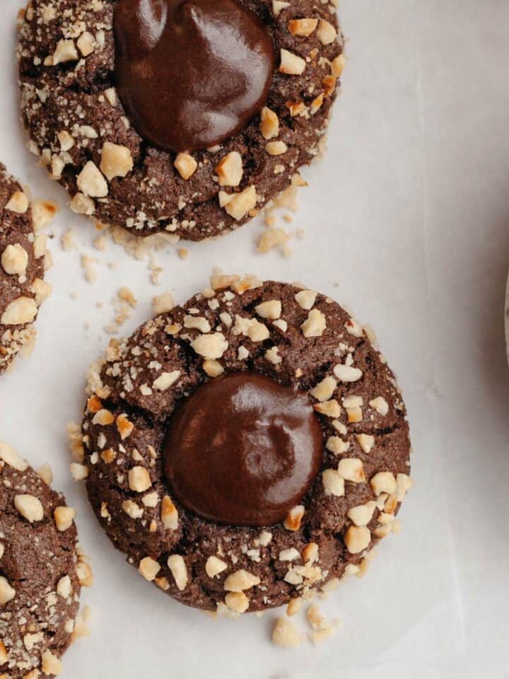 Nutella thumbprint cookies covered in chopped hazelnuts.