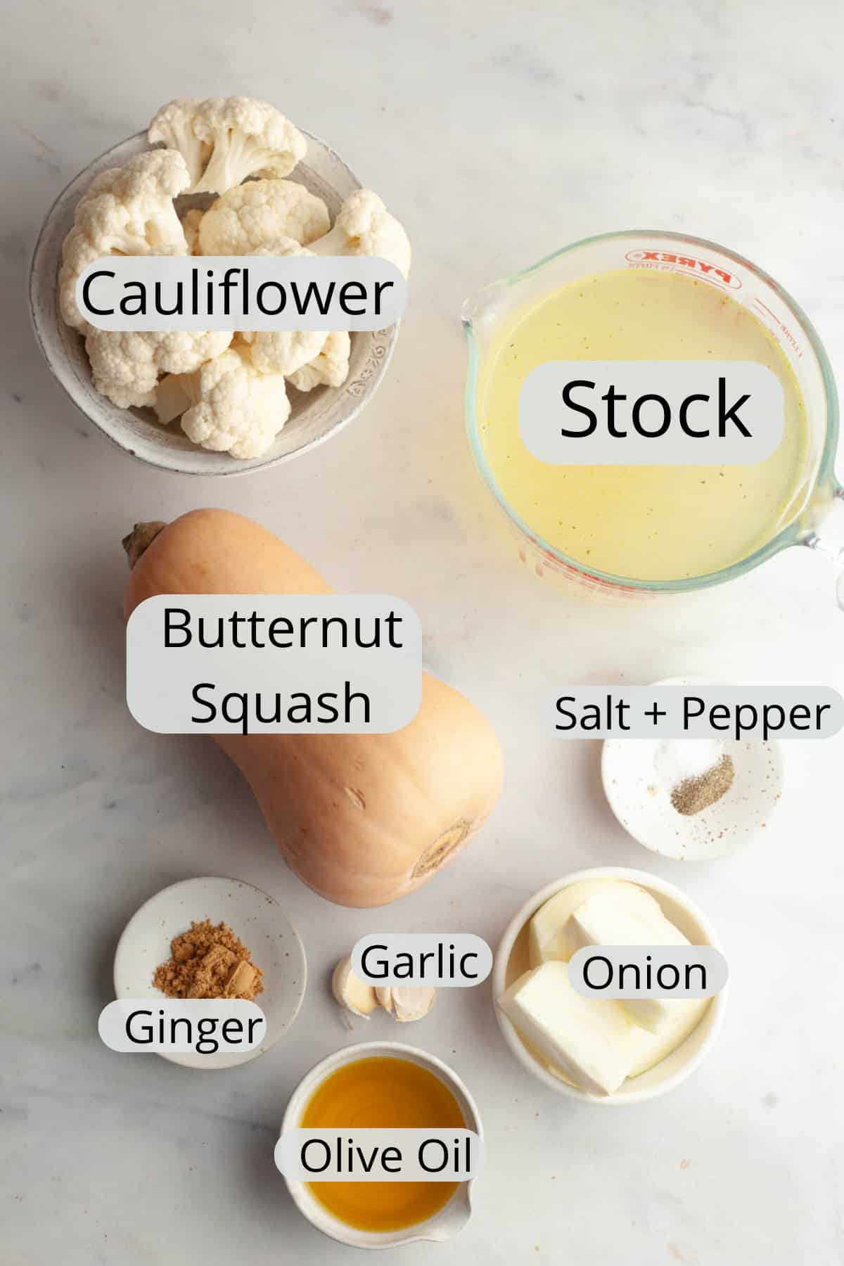 All the ingredients needed to make butternut squash cauliflower soup, in small bowls.