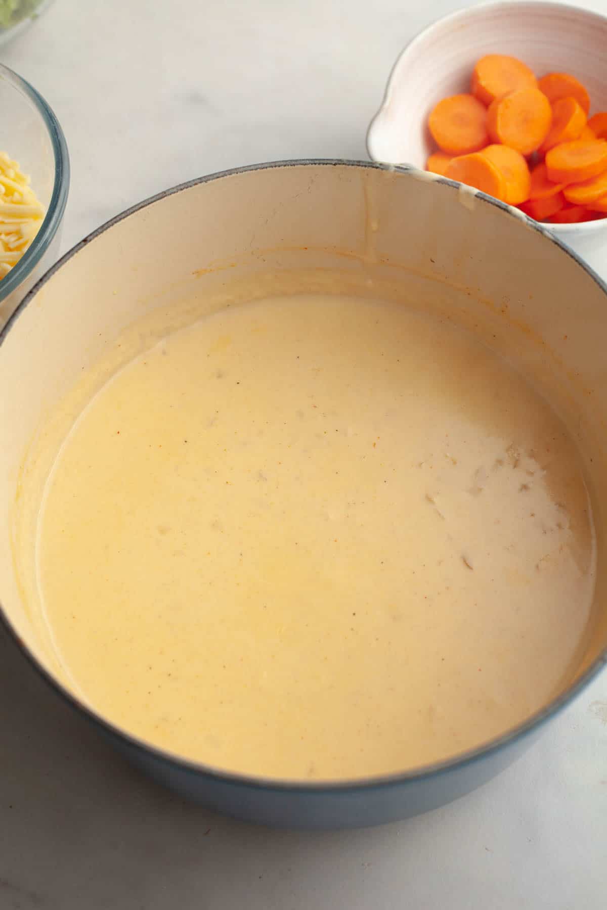 A large dutch oven with soup in it.