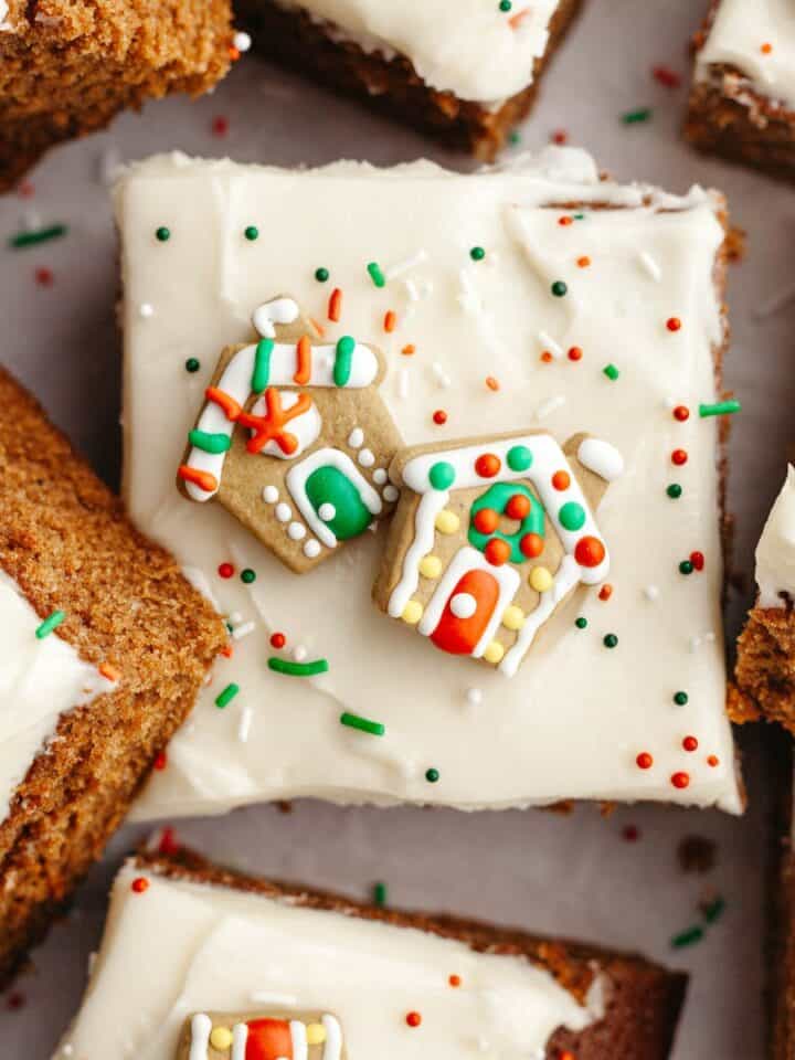 Square slices of frosted gingerbread cake with Christmas sprinkles.
