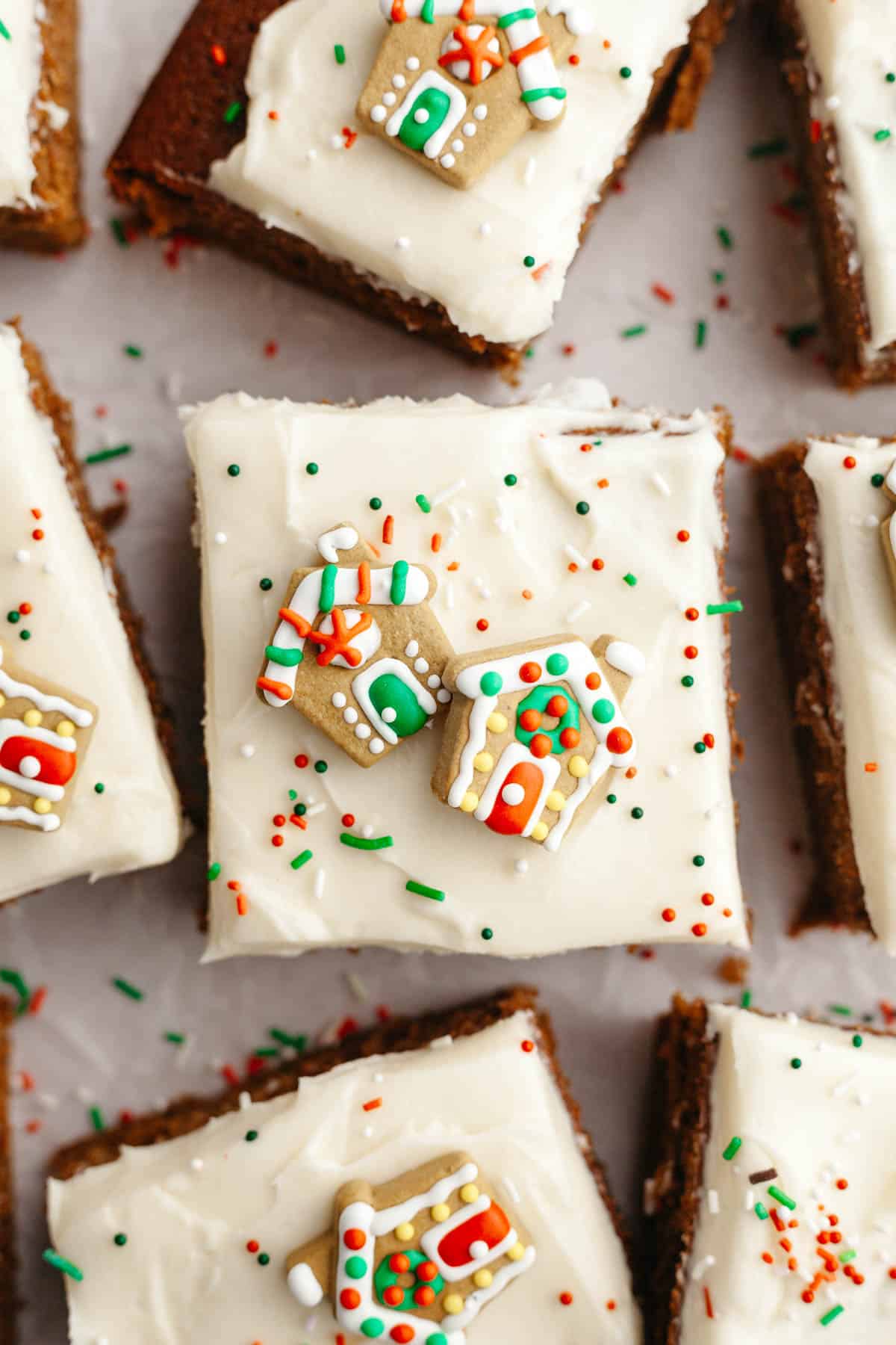 Square slices of frosted gingerbread cake with Christmas sprinkles.