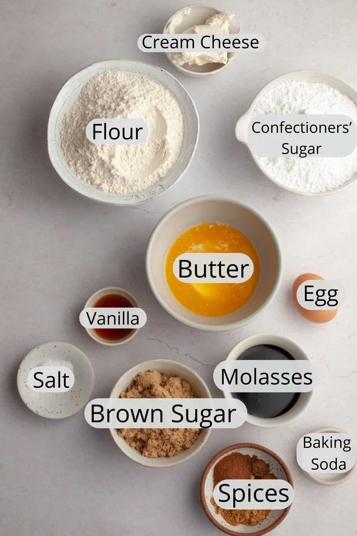 All the ingredients needed to make a frosted gingerbread cake, weighed out into small bowls.