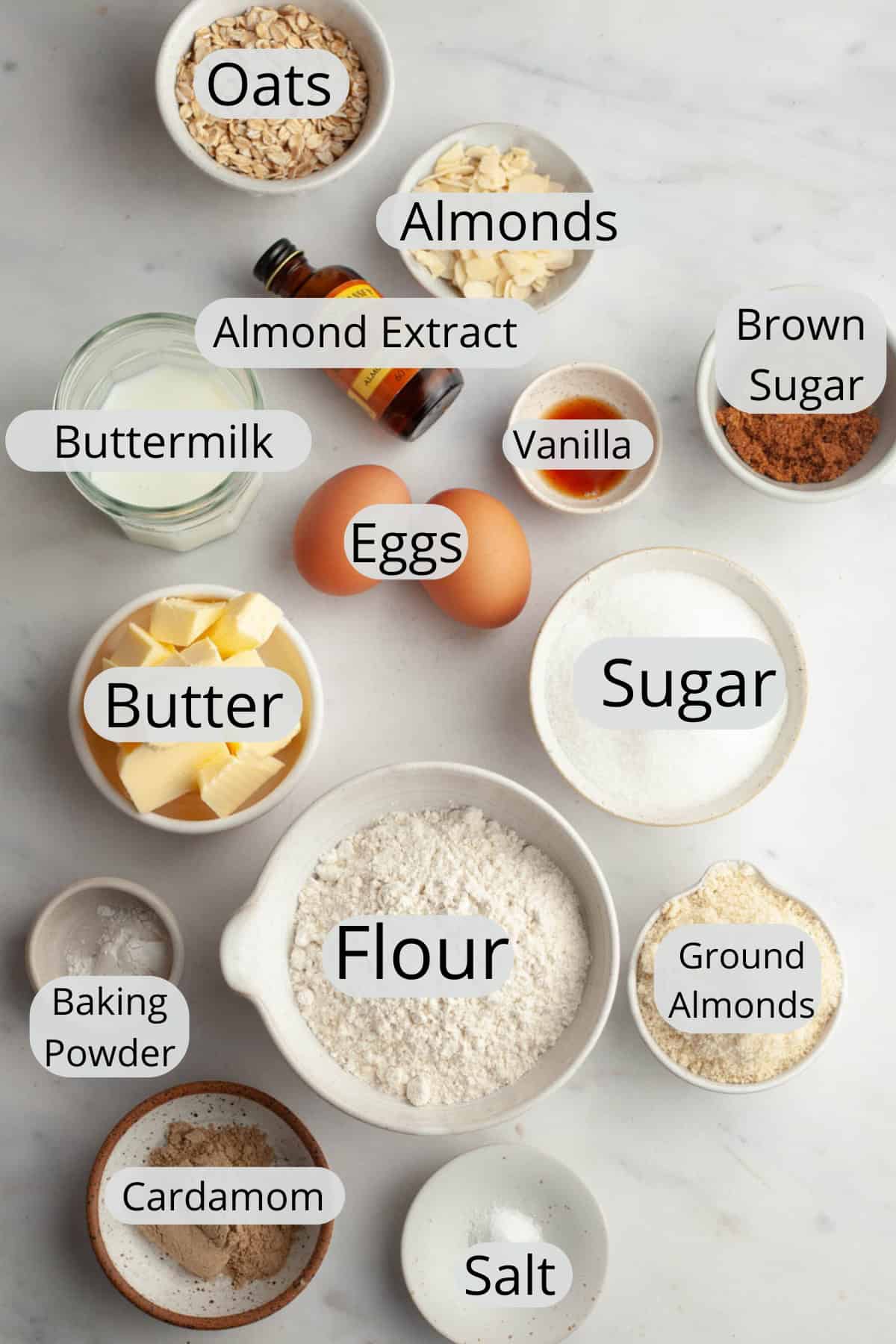 All the ingredients needed to make a cardamom almond cake, weighed out into small bowls.