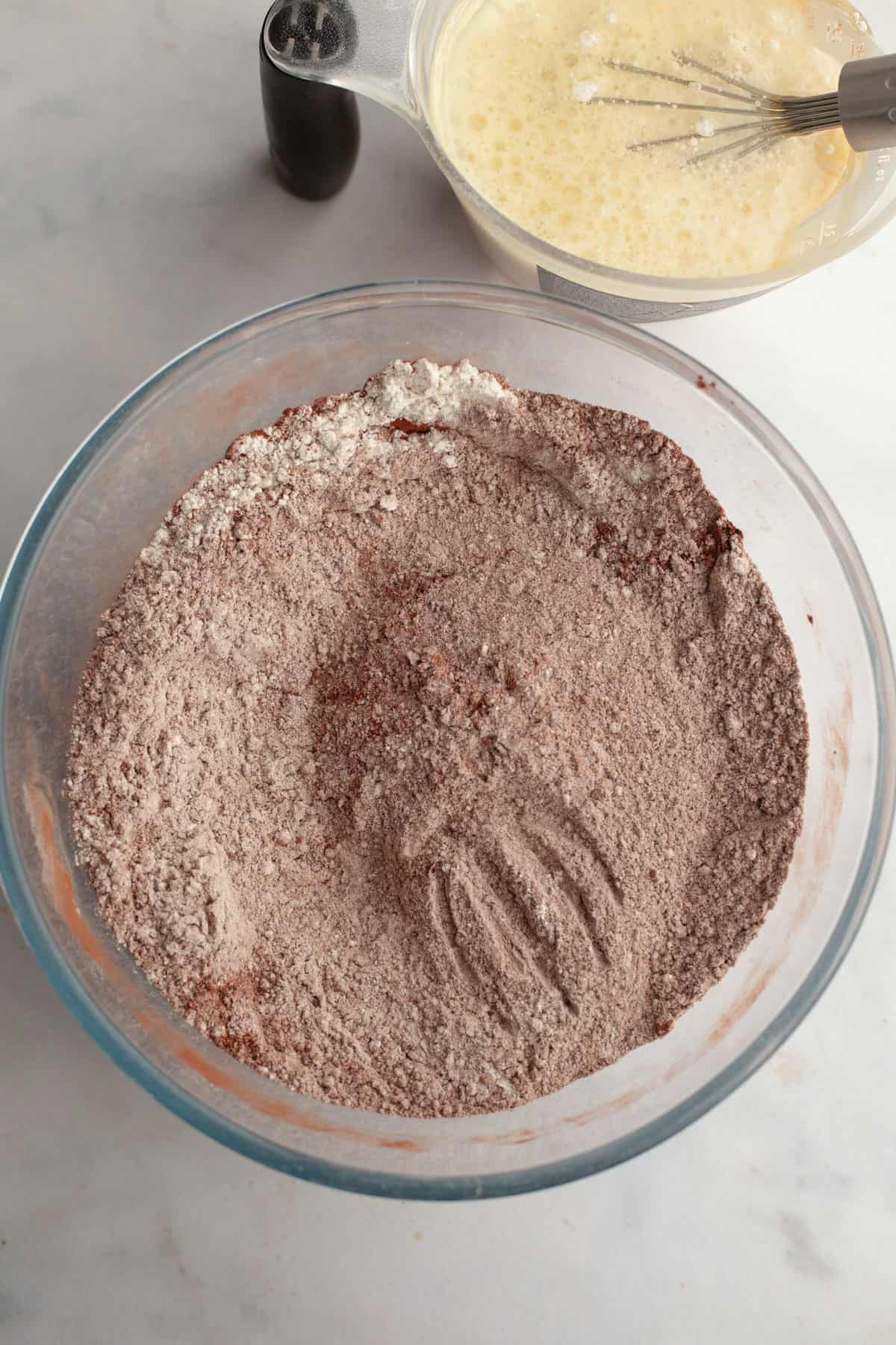Cocoa powder and flour in a glass bowl.