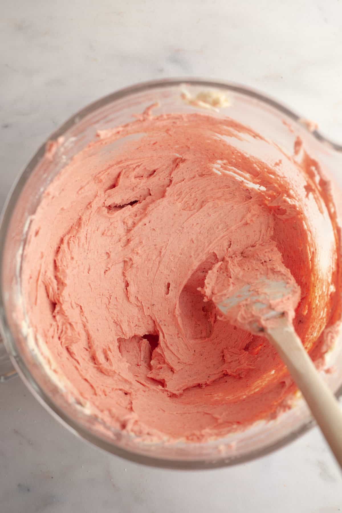 Strawberry buttercream in a large glass bowl.