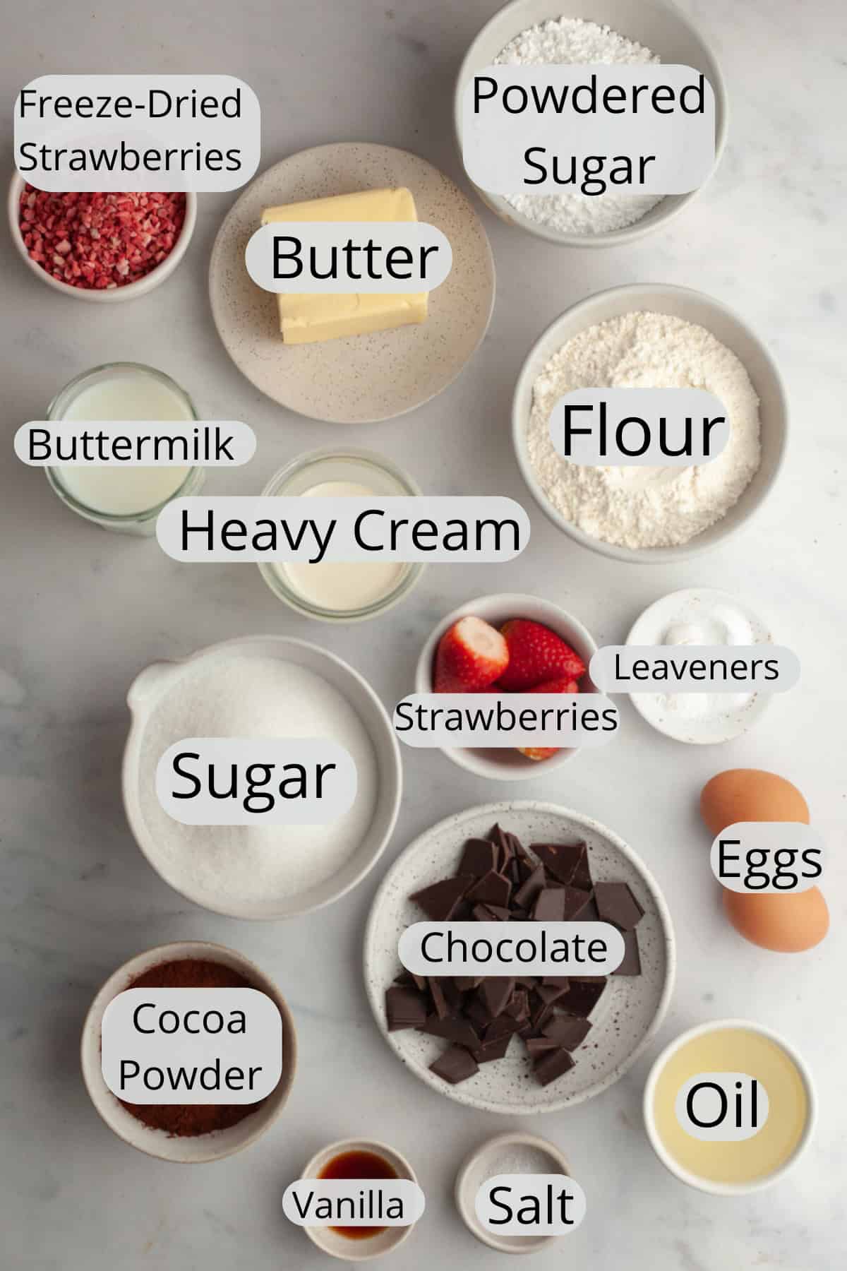 All the ingredients needed to make a chocolate covered strawberry cake, weighed out into small bowls.