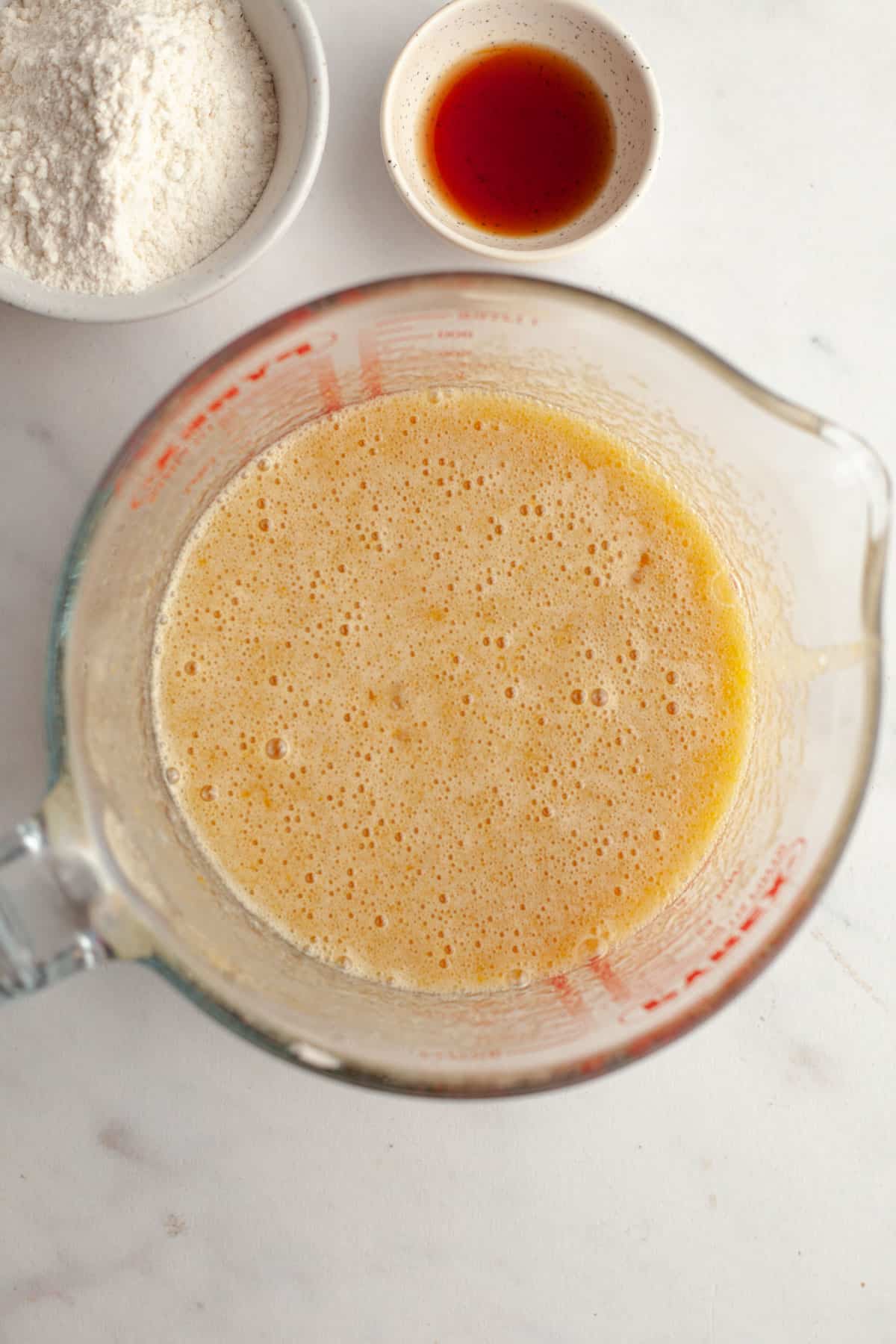 A large jug with whisked sugar and eggs in it.