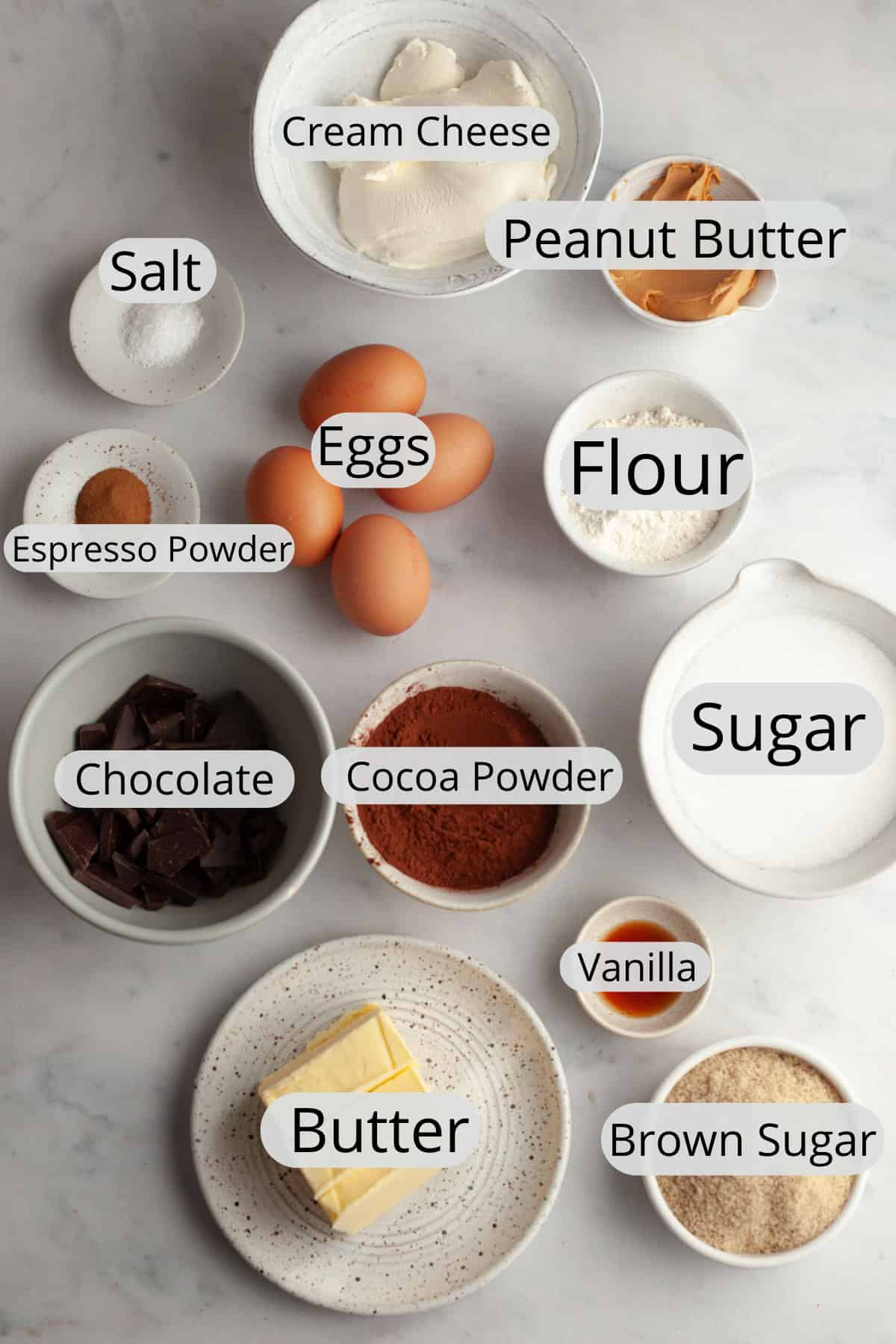 All the ingredients needed to make peanut butter cream cheese brownies, weighed out into small bowls.