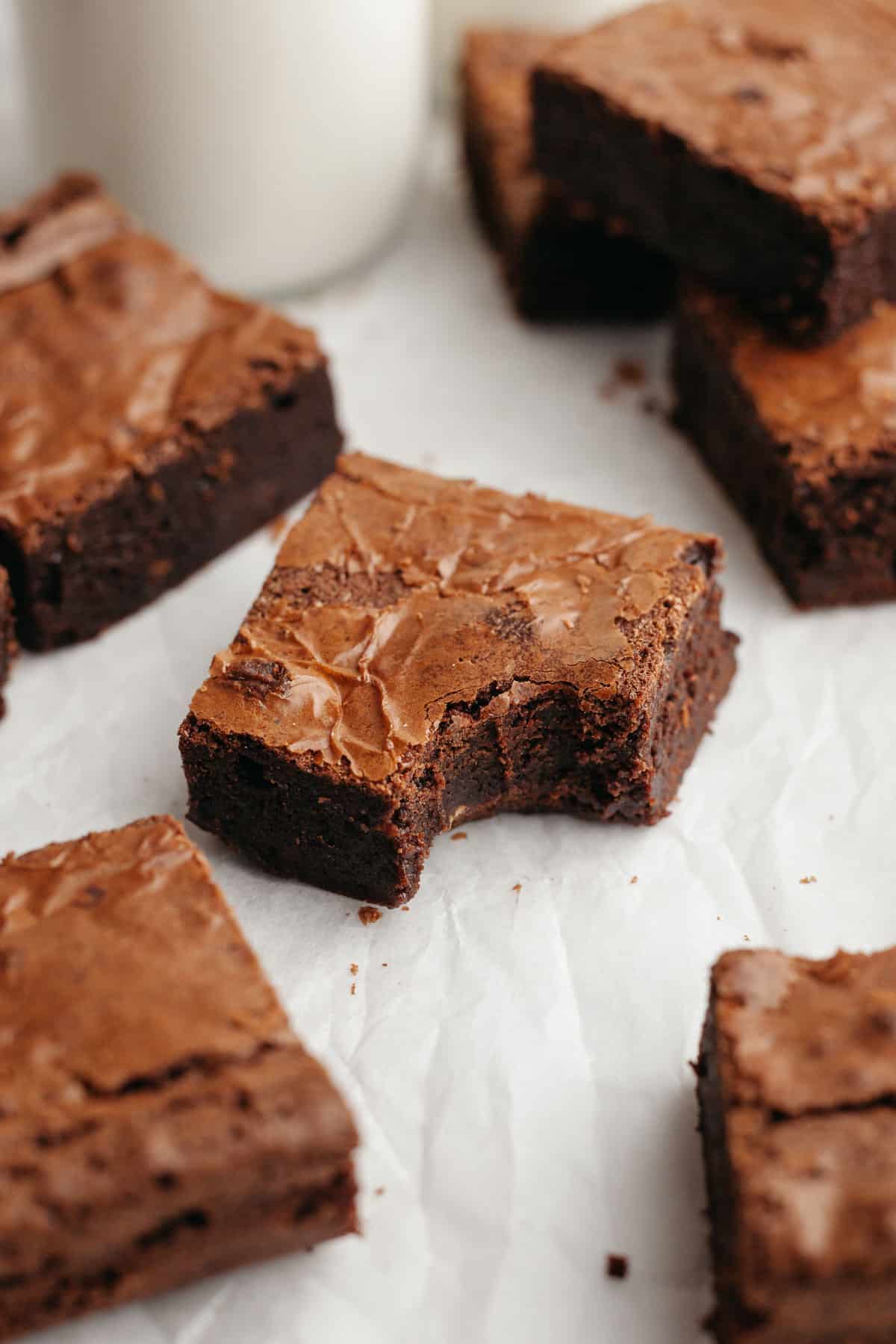 A double fudge brownie with a bite taken out of it.