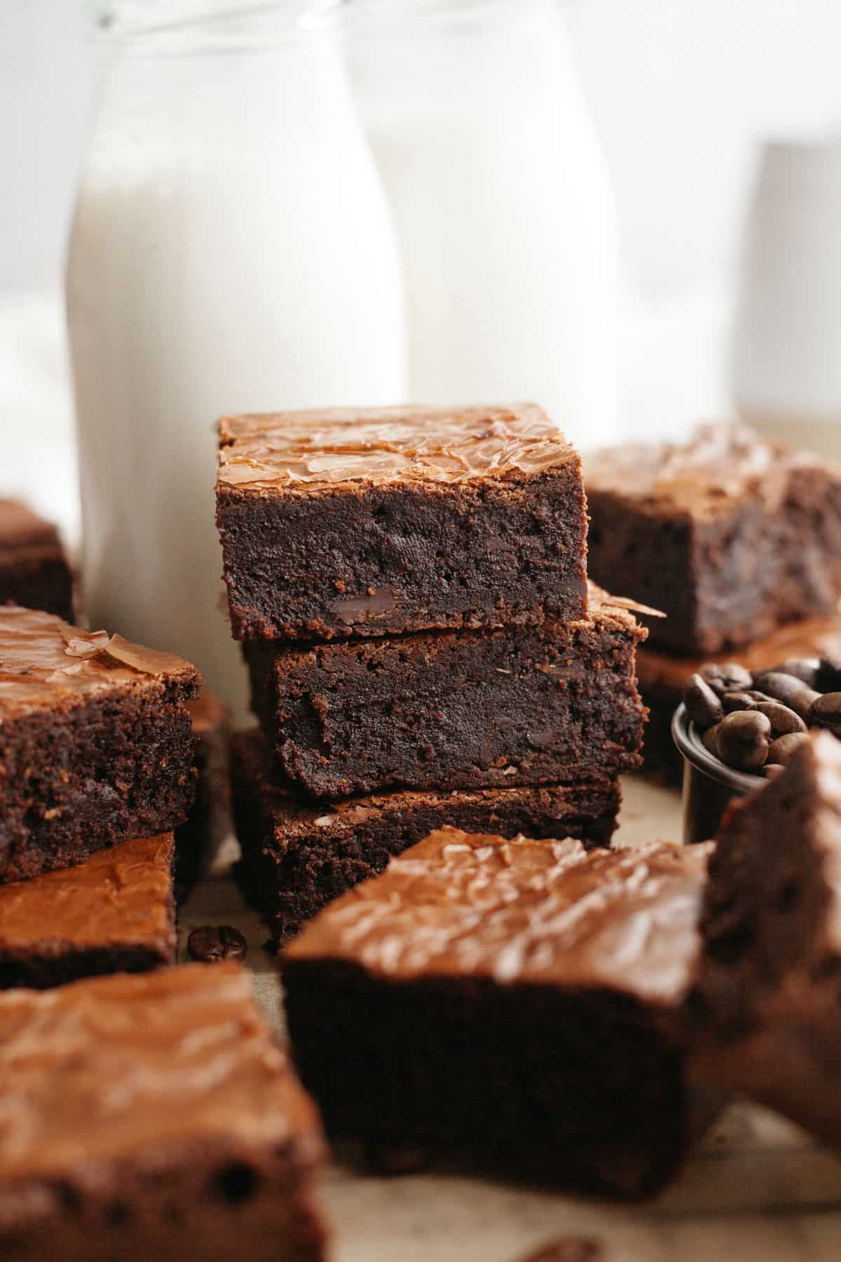 A stack of three fudgy espresso brownies on parchment paper.