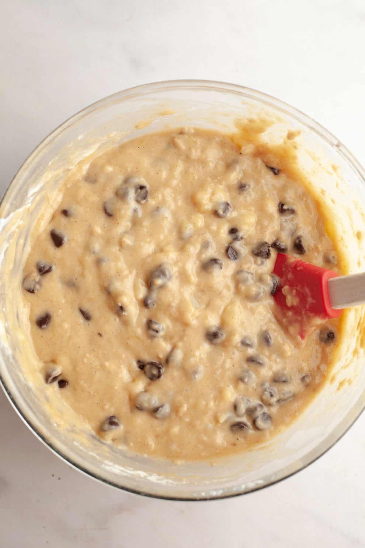 Banana chocolate chip muffin batter in a bowl.