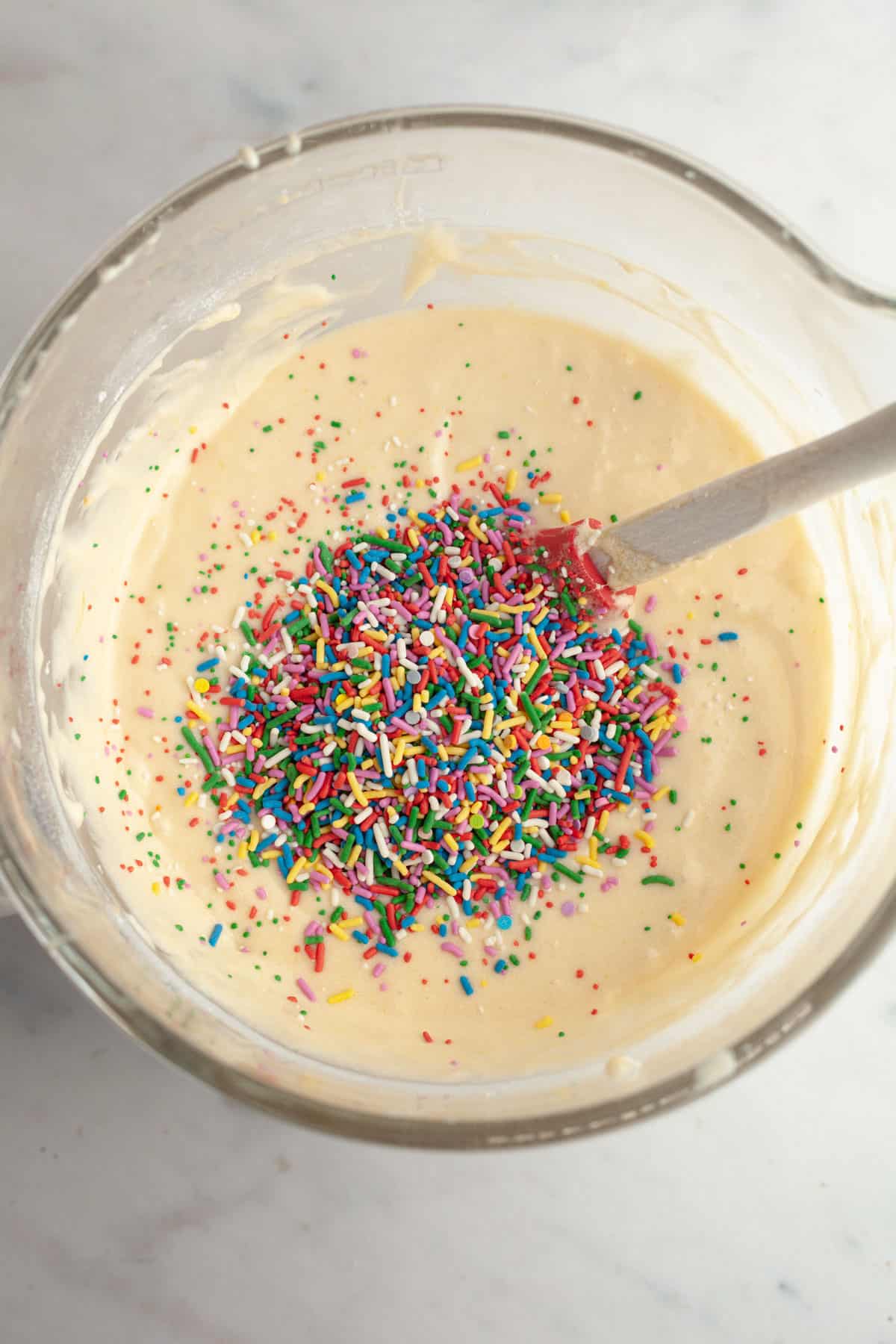 Cake batter in a bowl with sprinkles.