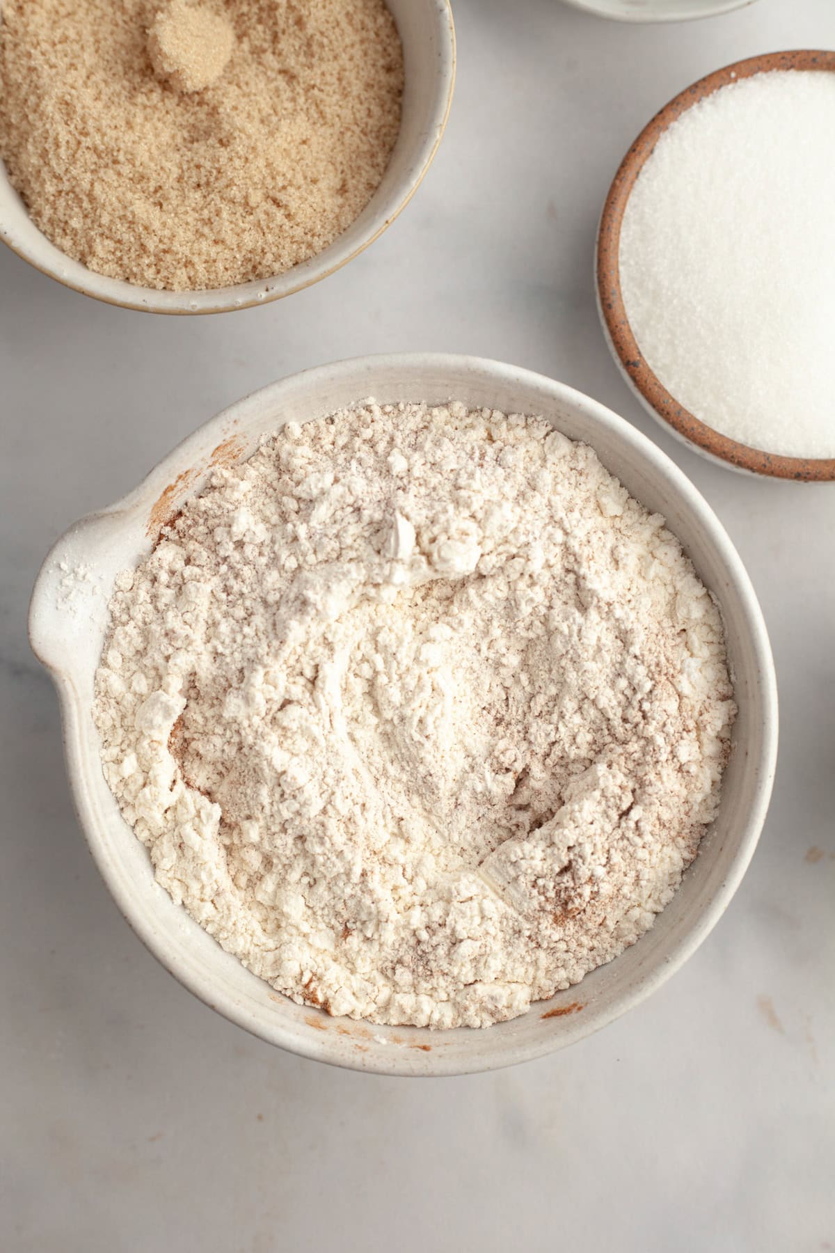 Flour and cinnamon mixed together in a bowl.