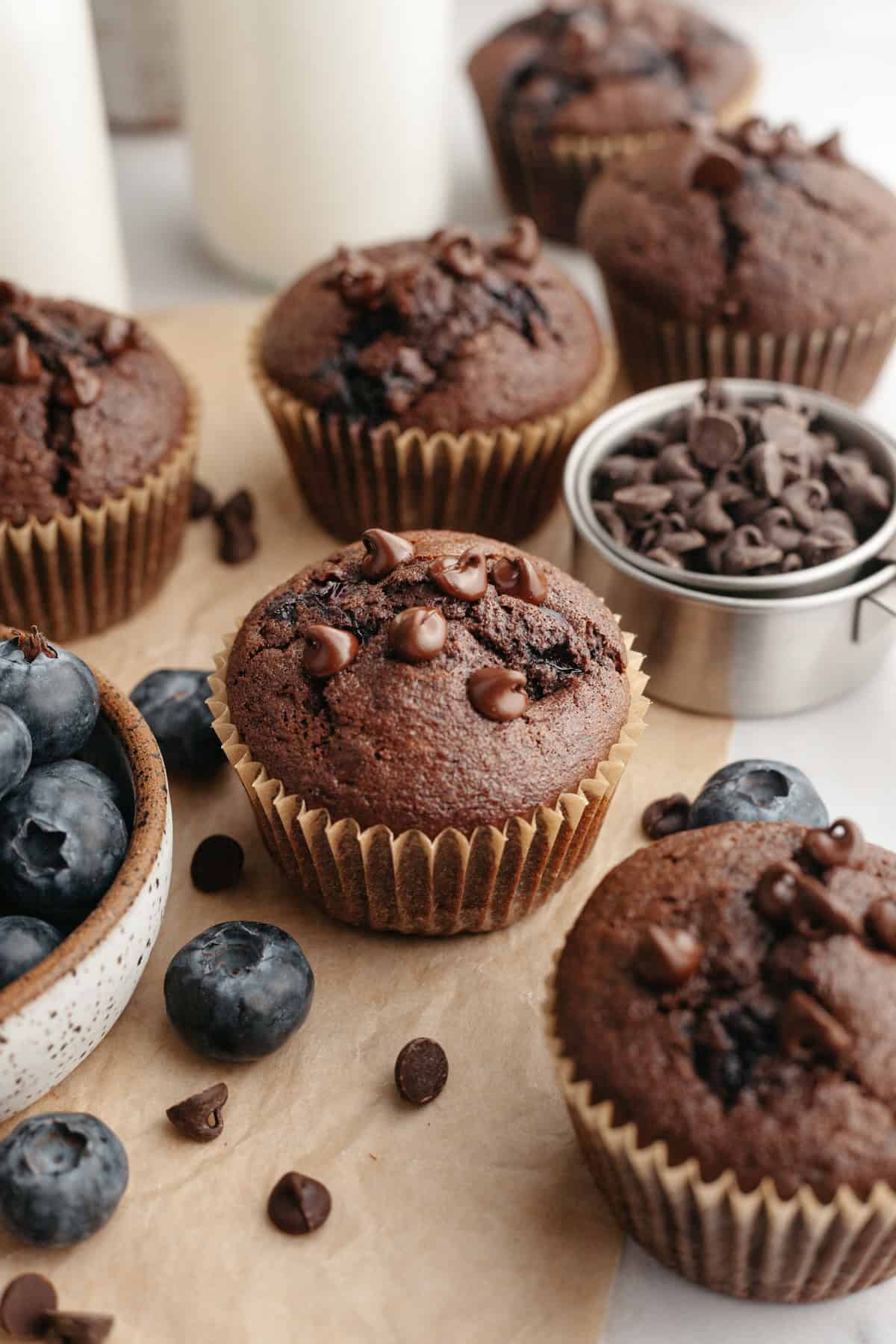 A blueberry chocolate muffin on parchment paper.