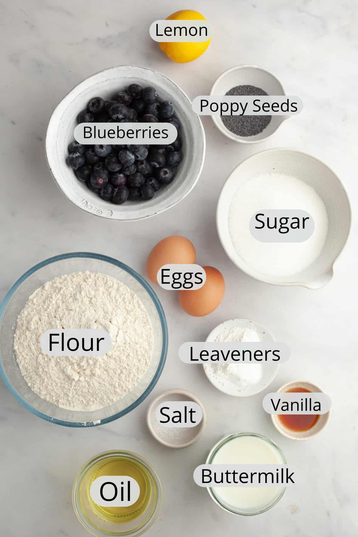 All the ingredients needed to make blueberry lemon poppy seed muffins, weighed out into small bowls.