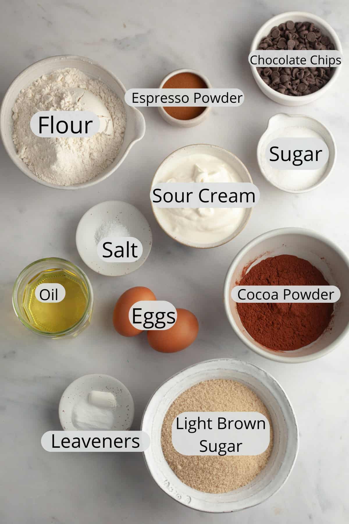 All the ingredients needed to make double chocolate espresso muffins, weighed out into small bowls.