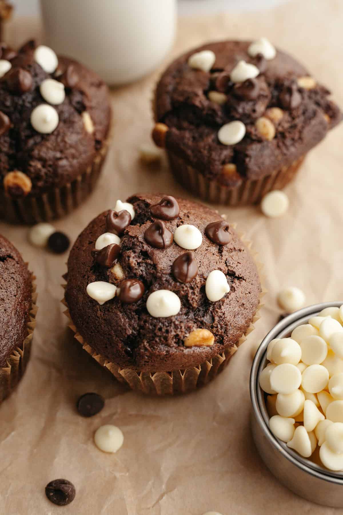 Triple chocolate muffins on parchment paper.