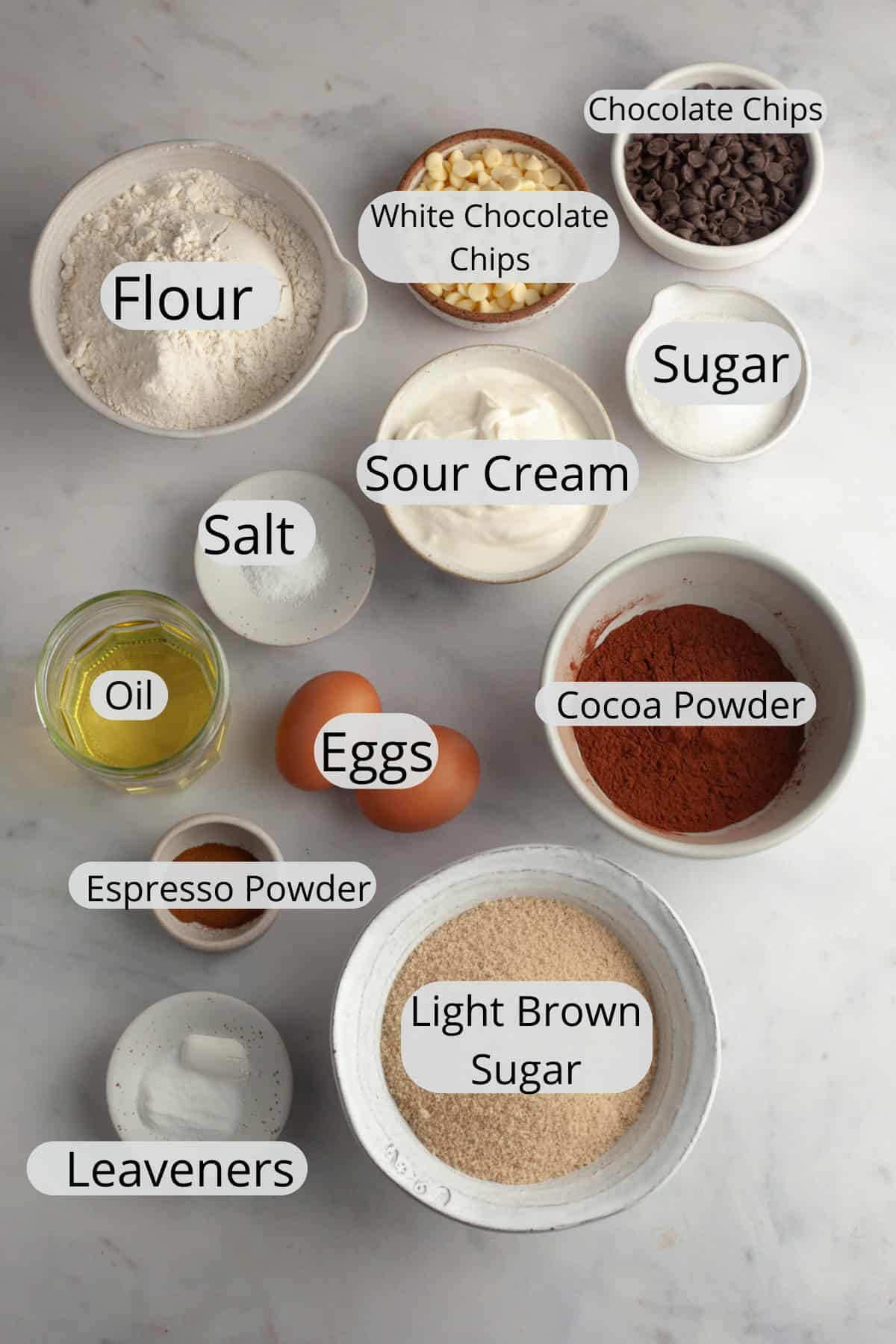 All the ingredients needed to make triple chocolate muffins, weighed out into small bowls.