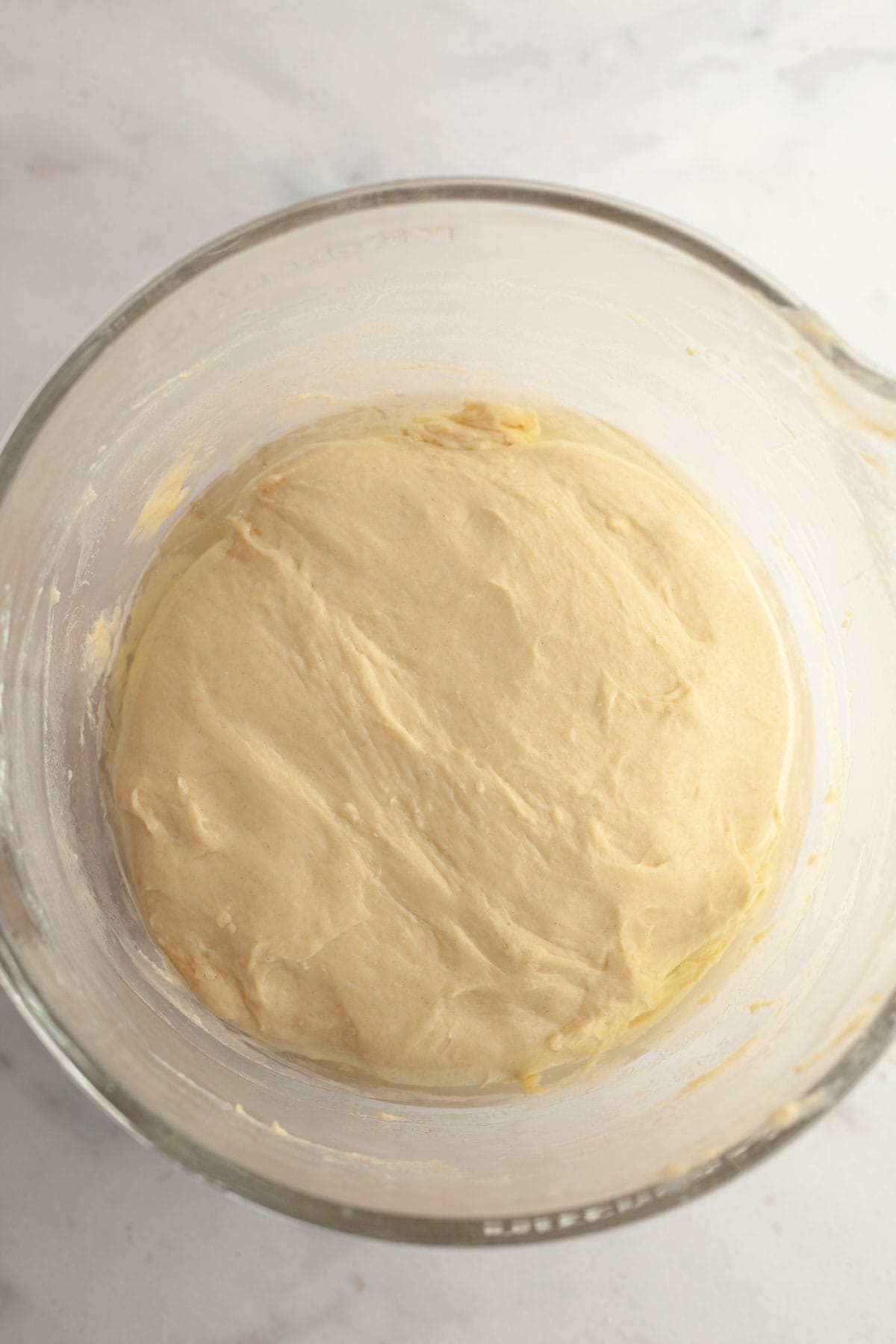 Cinnamon roll dough in a glass bowl.