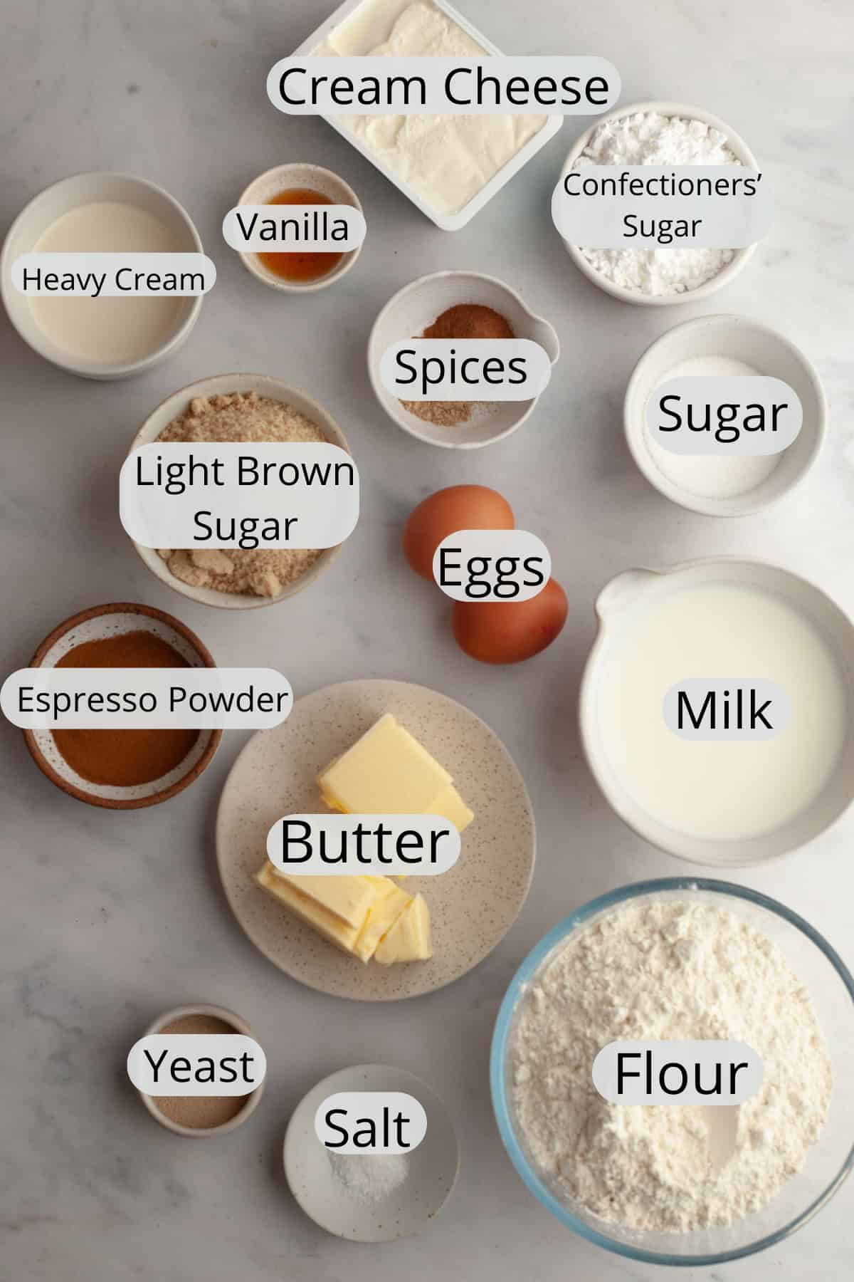 All the ingredients needed to make cinnamon coffee rolls, weighed out into small bowls.