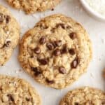 Oatmeal chocolate chip coconut cookies on parchment paper.