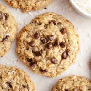 Oatmeal chocolate chip coconut cookies on parchment paper.