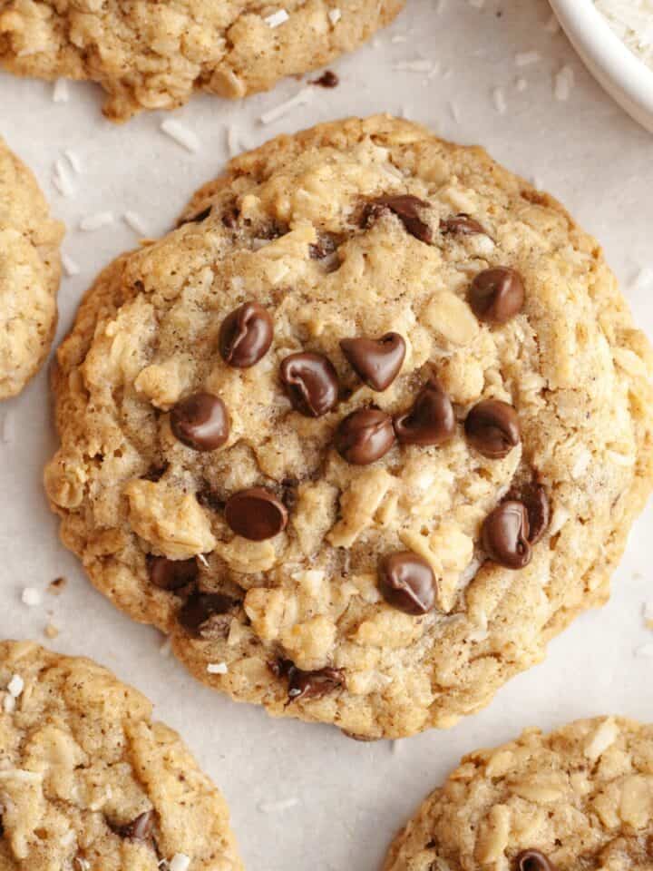 Oatmeal chocolate chip coconut cookies on parchment paper.