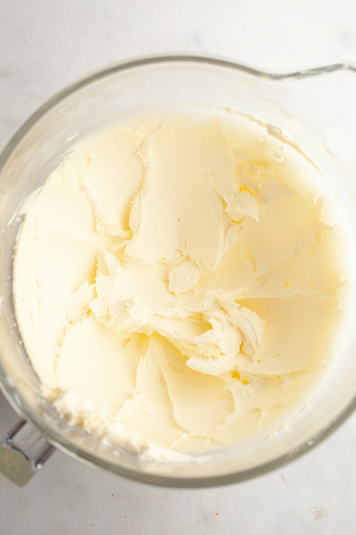 Vanilla frosting in a large mixing bowl.