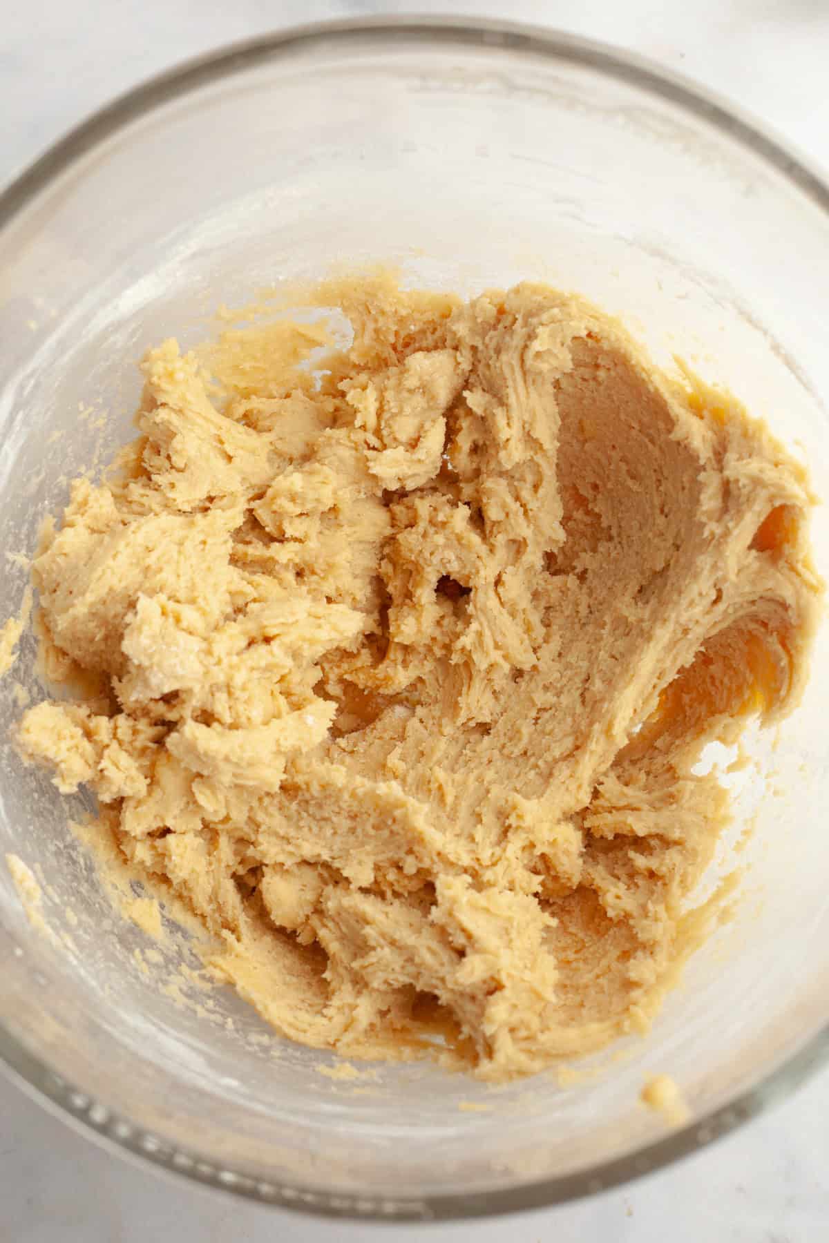 Cookie dough in a glass mixing bowl.