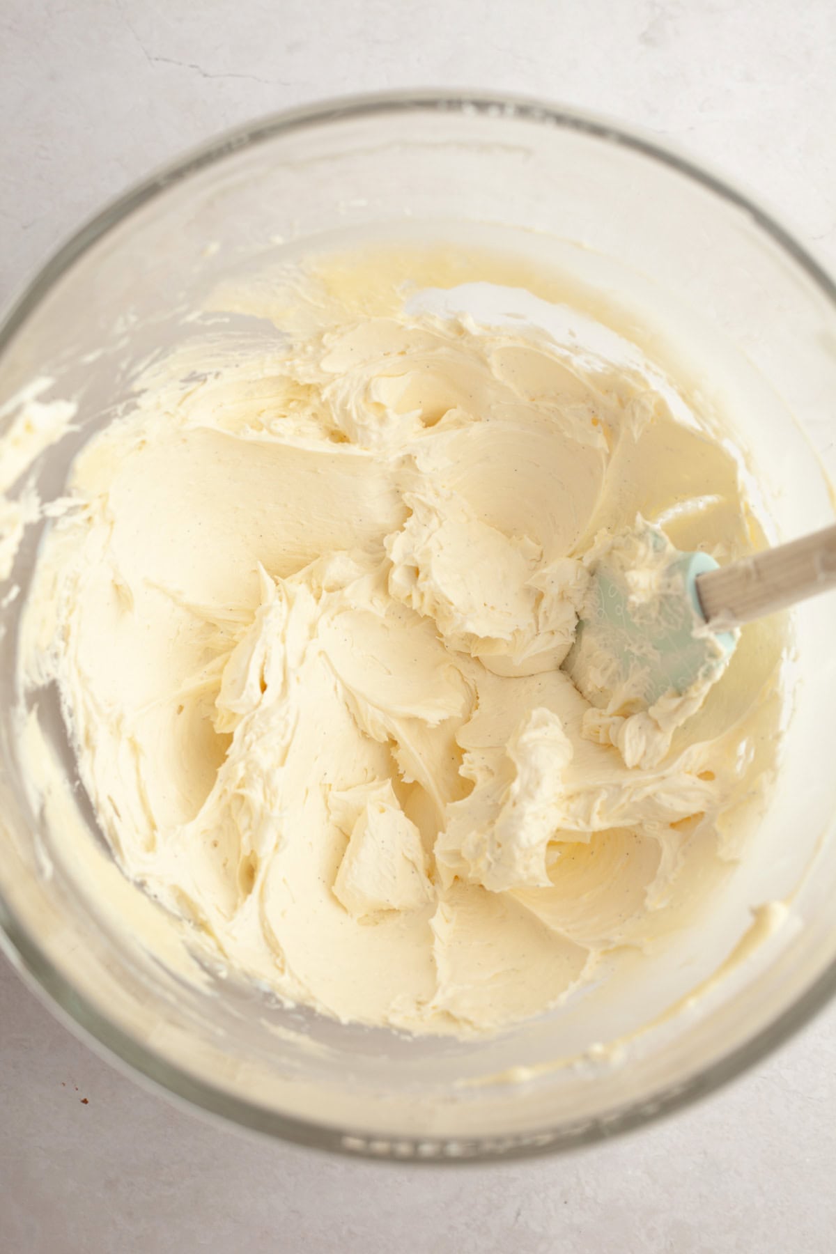 Vanilla bean frosting in a large glass bowl.