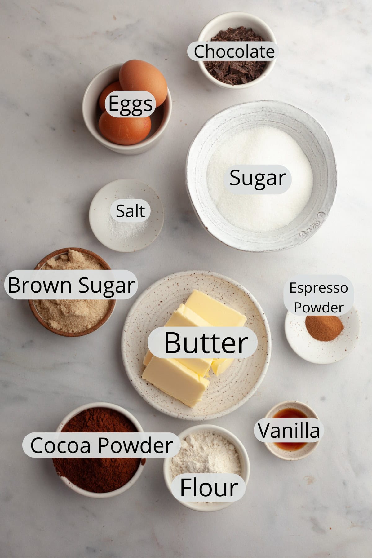 All the ingredients needed to make fudgy brown butter espresso brownies, weighed out into small bowls.