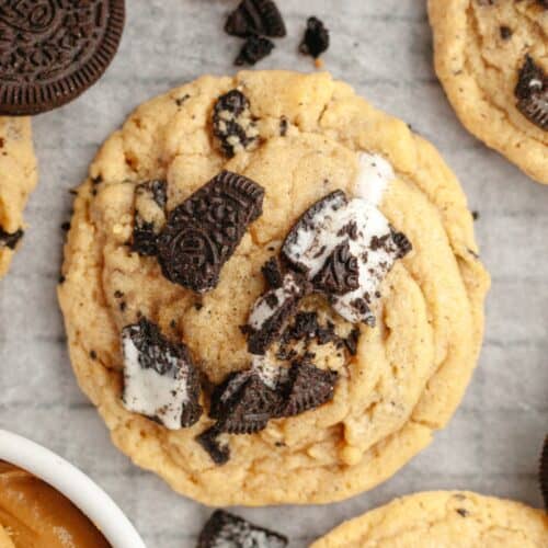 A close up of an Oreo peanut butter cookie on parchment paper.