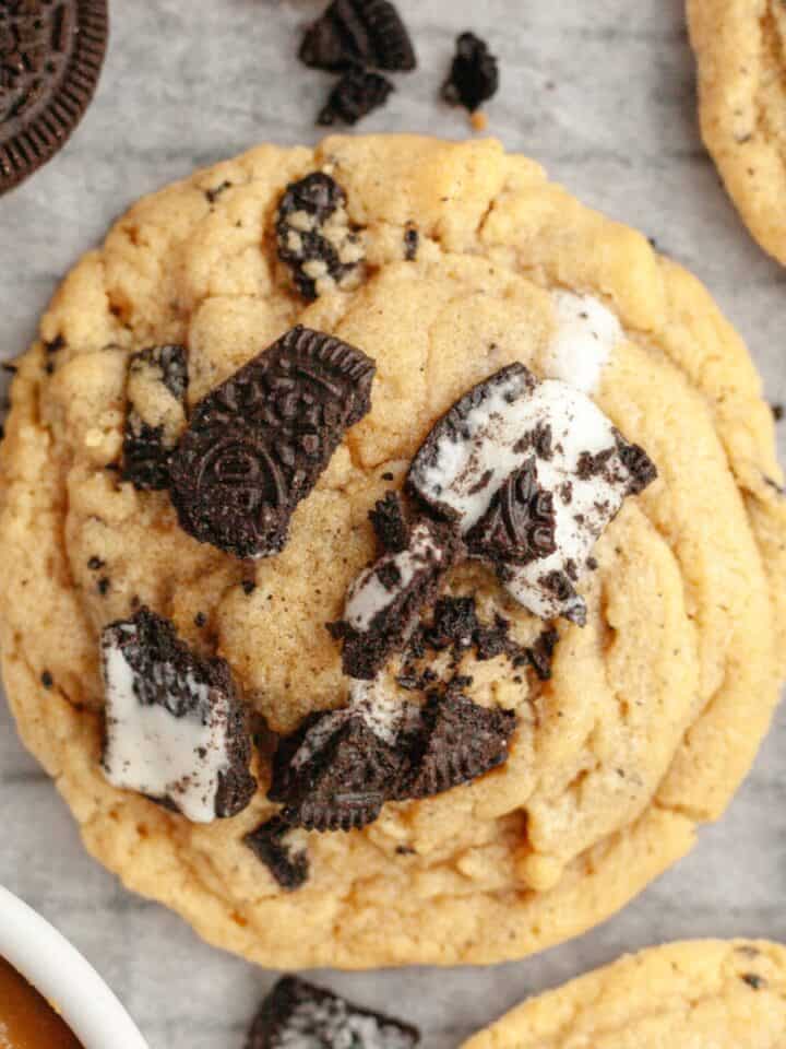 A close up of an Oreo peanut butter cookie on parchment paper.