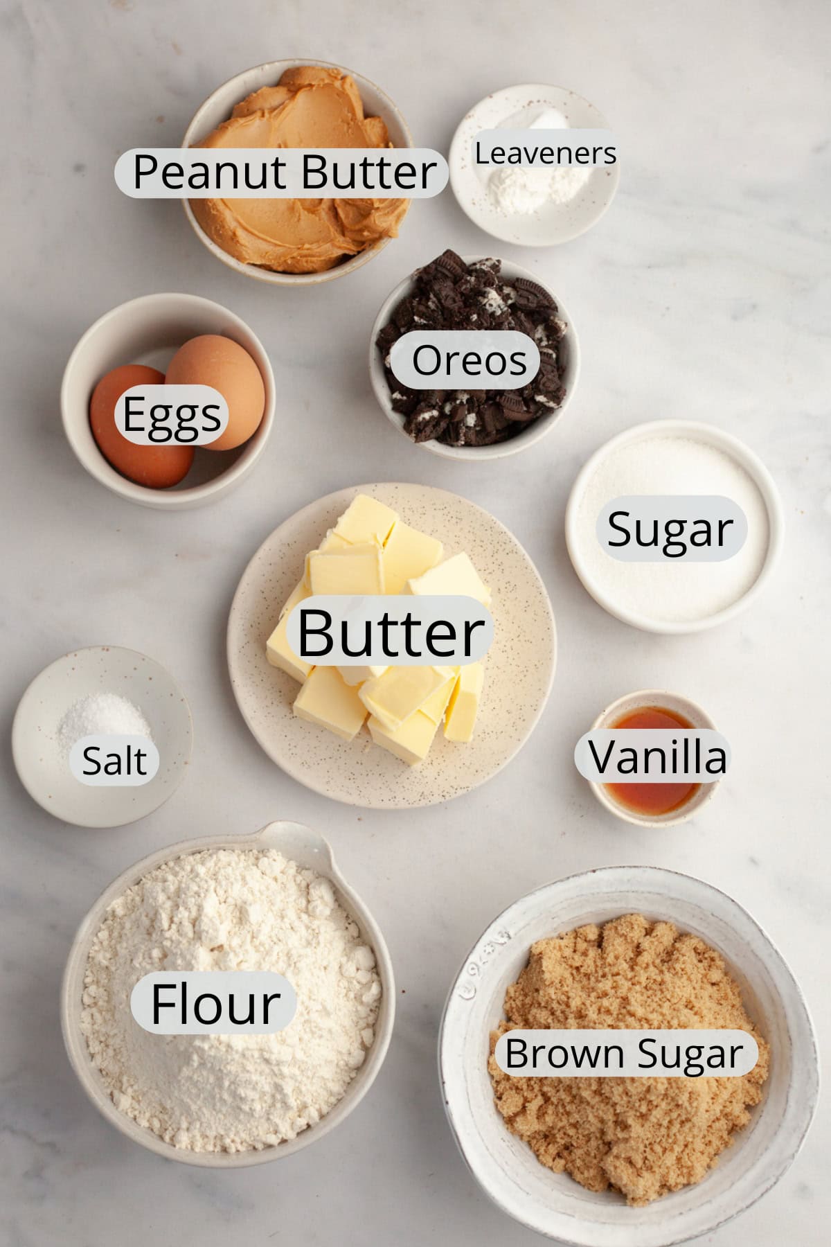 All the ingredients needed to make peanut butter Oreo cookies, weighed out into small bowls.