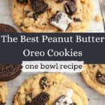 A close up of peanut butter Oreo cookies on parchment paper, one has a bite taken out of it.