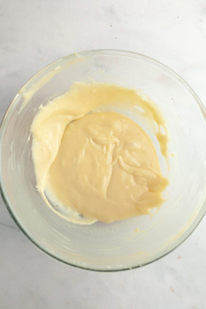White chocolate ganache in a bowl.