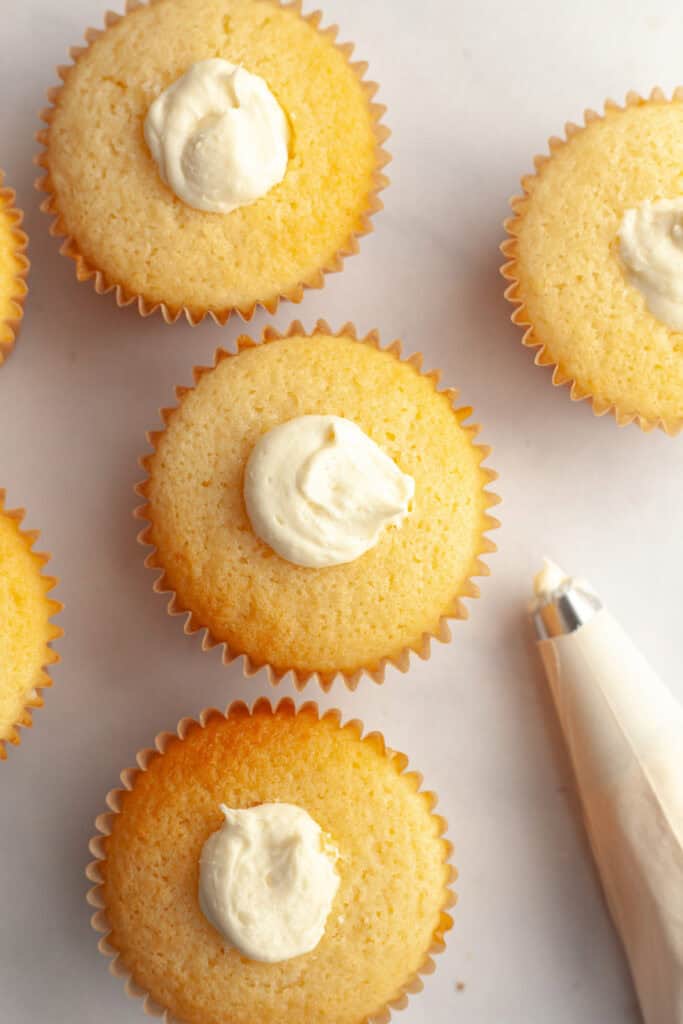 Vanilla cupcakes filled with white chocolate ganache.