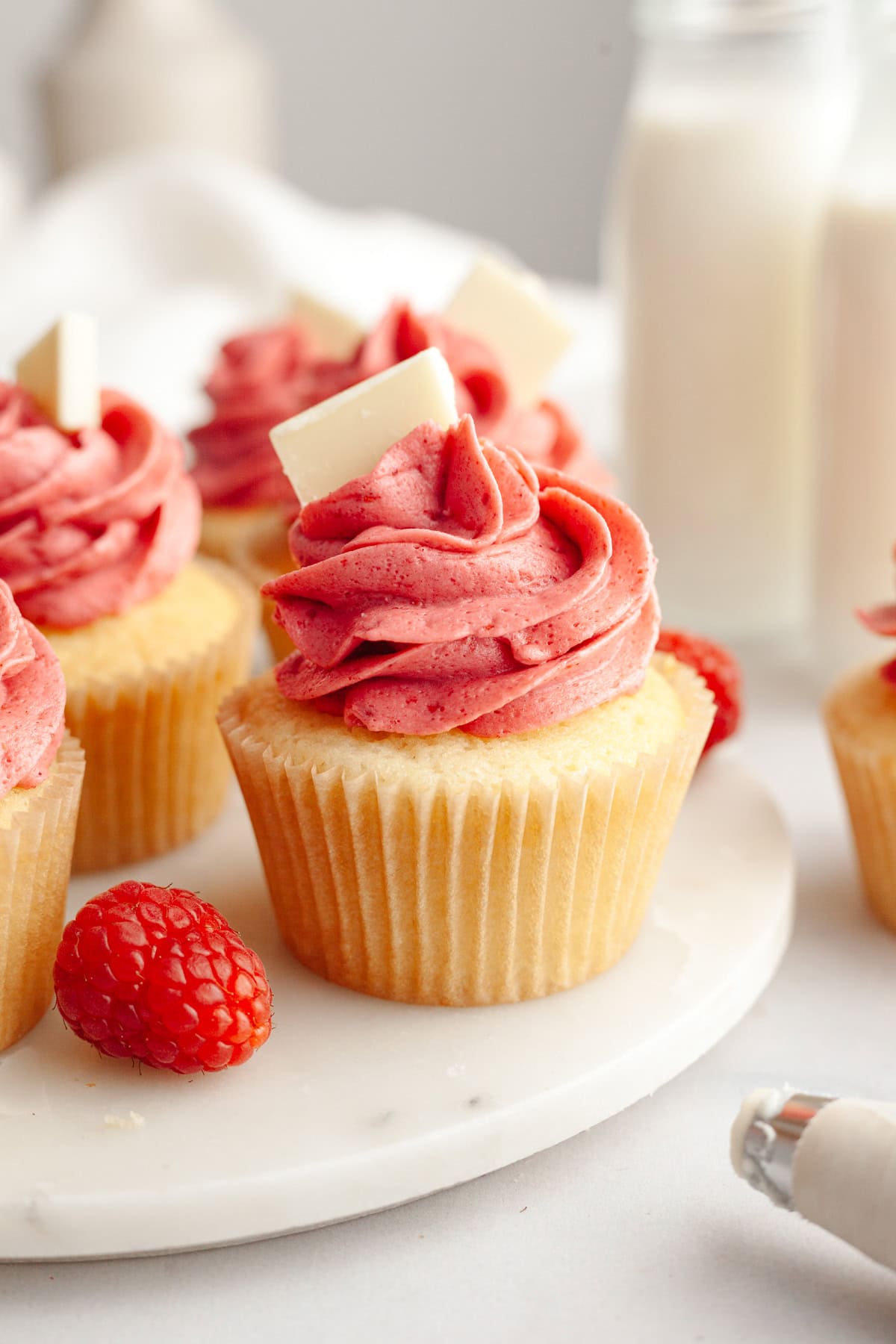 Vanilla cupcakes frosted with pink raspberry buttercream.