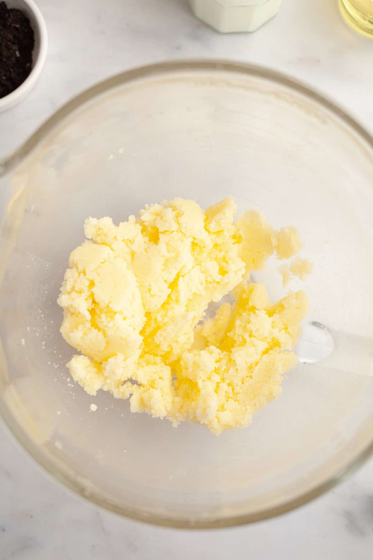 Creamed butter and sugar in a glass bowl.