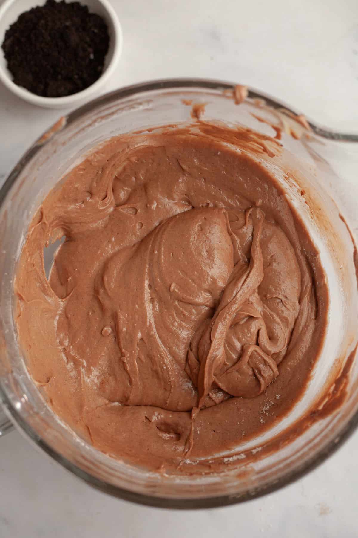 Red velvet cake batter in a glass bowl.