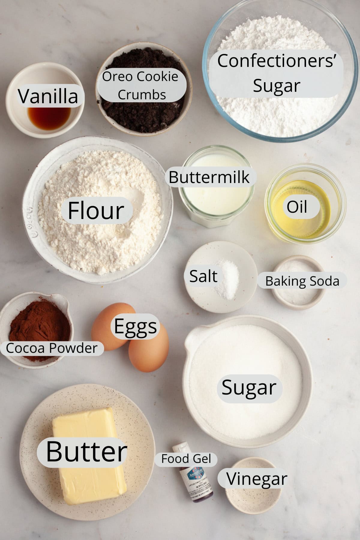 All the ingredients needed to make an Oreo red velvet cake, weighed out into small bowls.