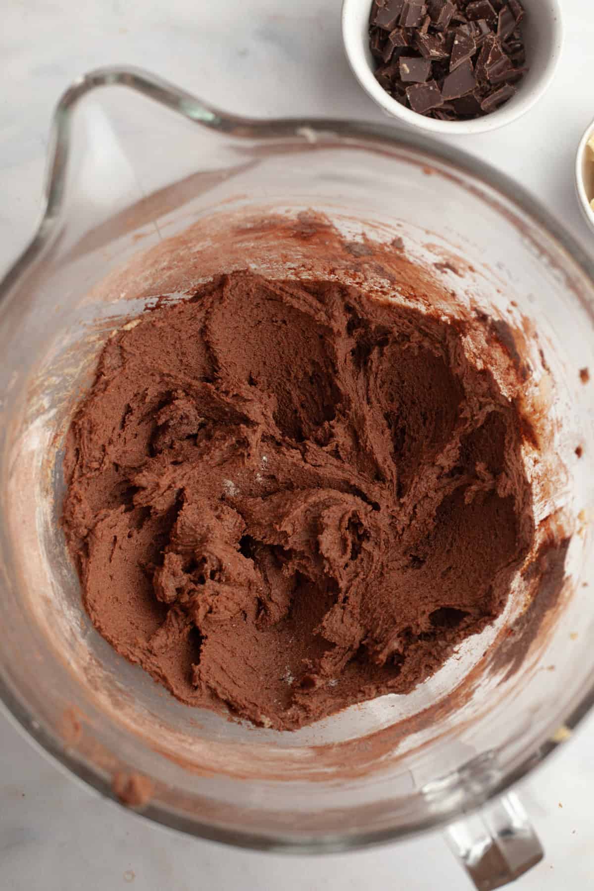 Chocolate cookie dough in a glass bowl.