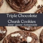 Triple chocolate chunk cookies on parchment paper, one has a bite taken out of it.